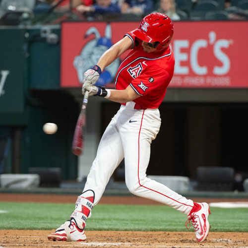 baseball player swinging at a pitch